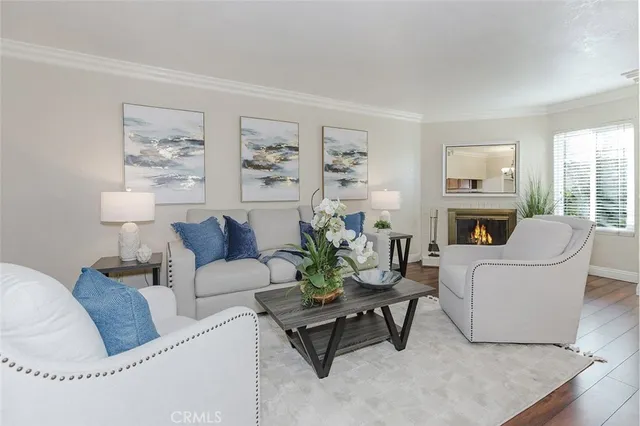a living room with furniture fireplace and a large window
