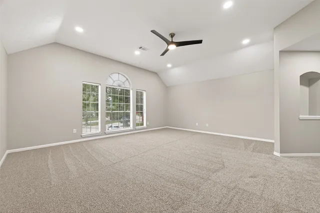 an empty room with windows and closet