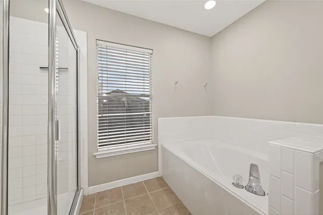 a bathroom with a bathtub and a shower