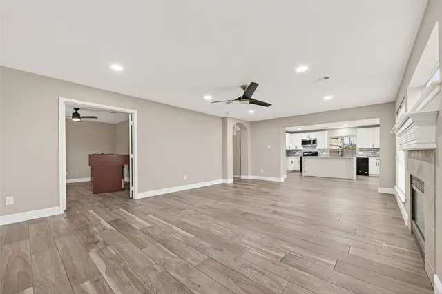 a view of empty room with wooden floor