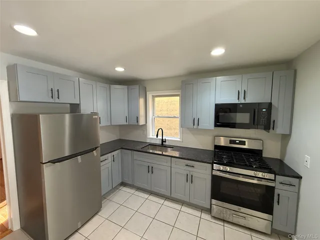 a kitchen with a sink a stove and refrigerator