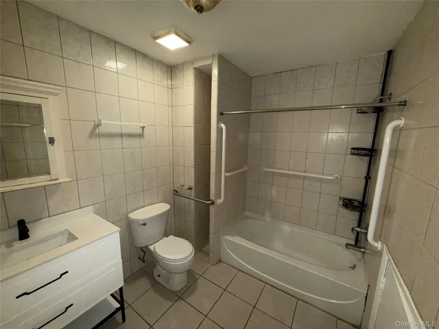 a bathroom with a toilet a sink and shower