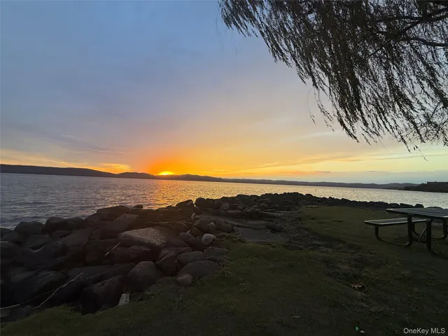 a view of an ocean and a mountain