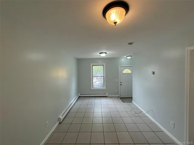 an empty room with windows and entrance