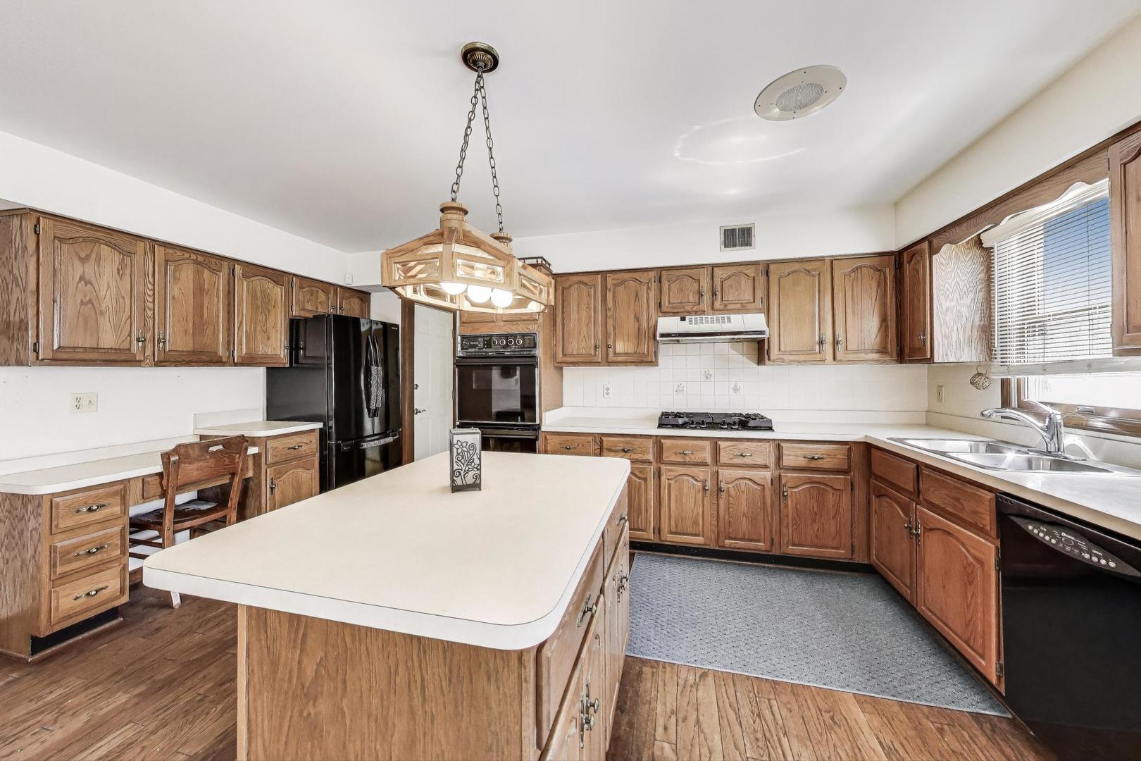 2080 Carolyn Road Aurora, IL 60506 - Photo 12 of 50 a kitchen with stainless steel appliances sink stove and cabinets