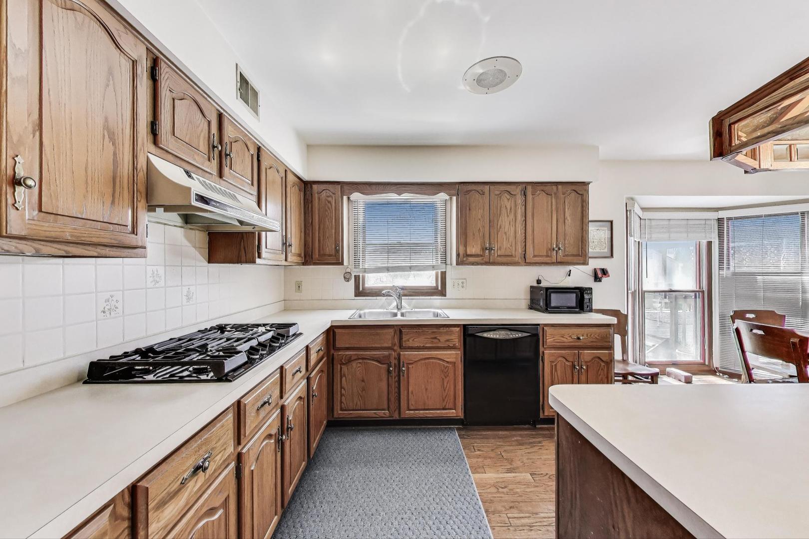 2080 Carolyn Road Aurora, IL 60506 - Photo 13 of 50 a kitchen with stainless steel appliances a sink stove and cabinets