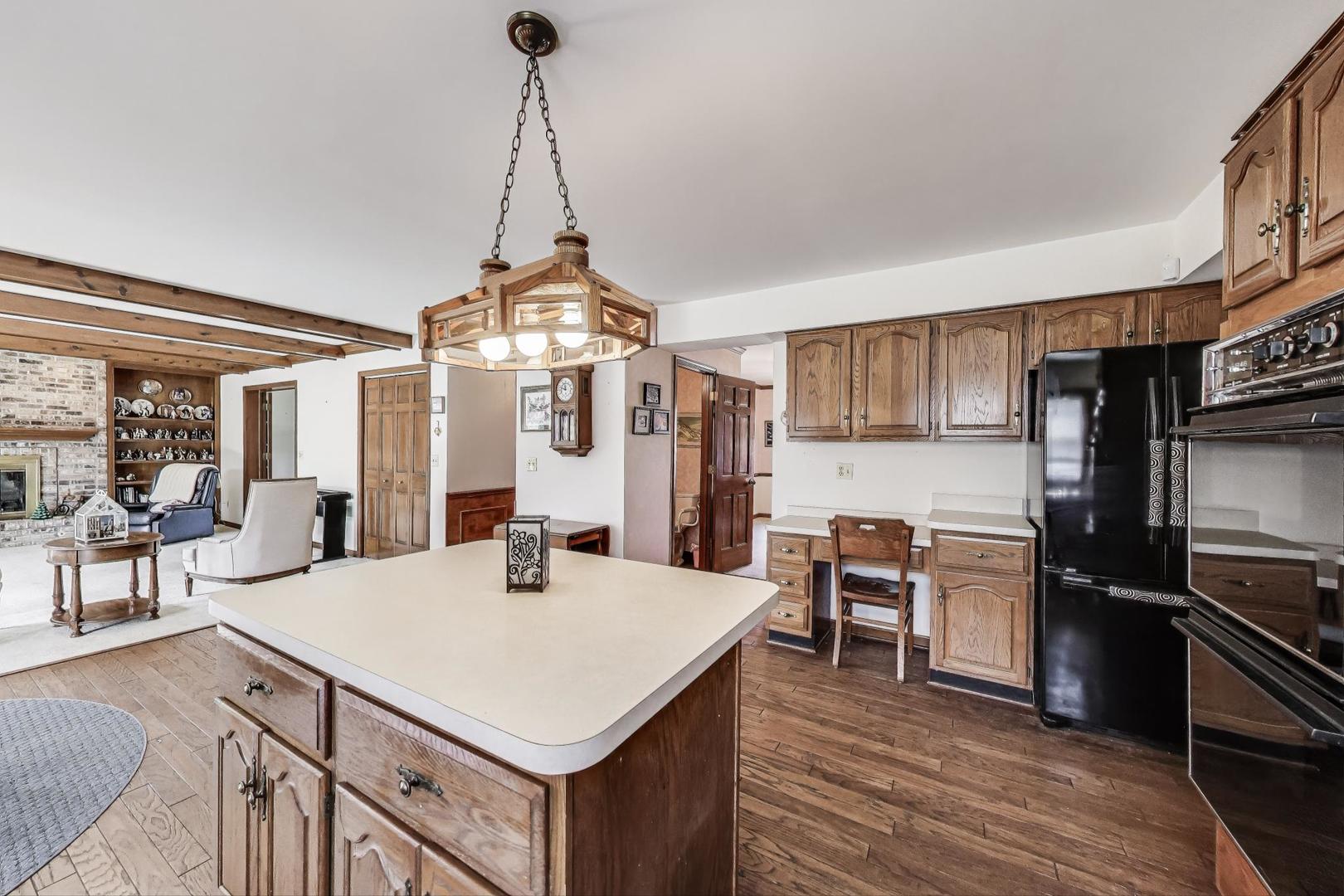 2080 Carolyn Road Aurora, IL 60506 - Photo 14 of 50 a kitchen with a stove a refrigerator and a dining table
