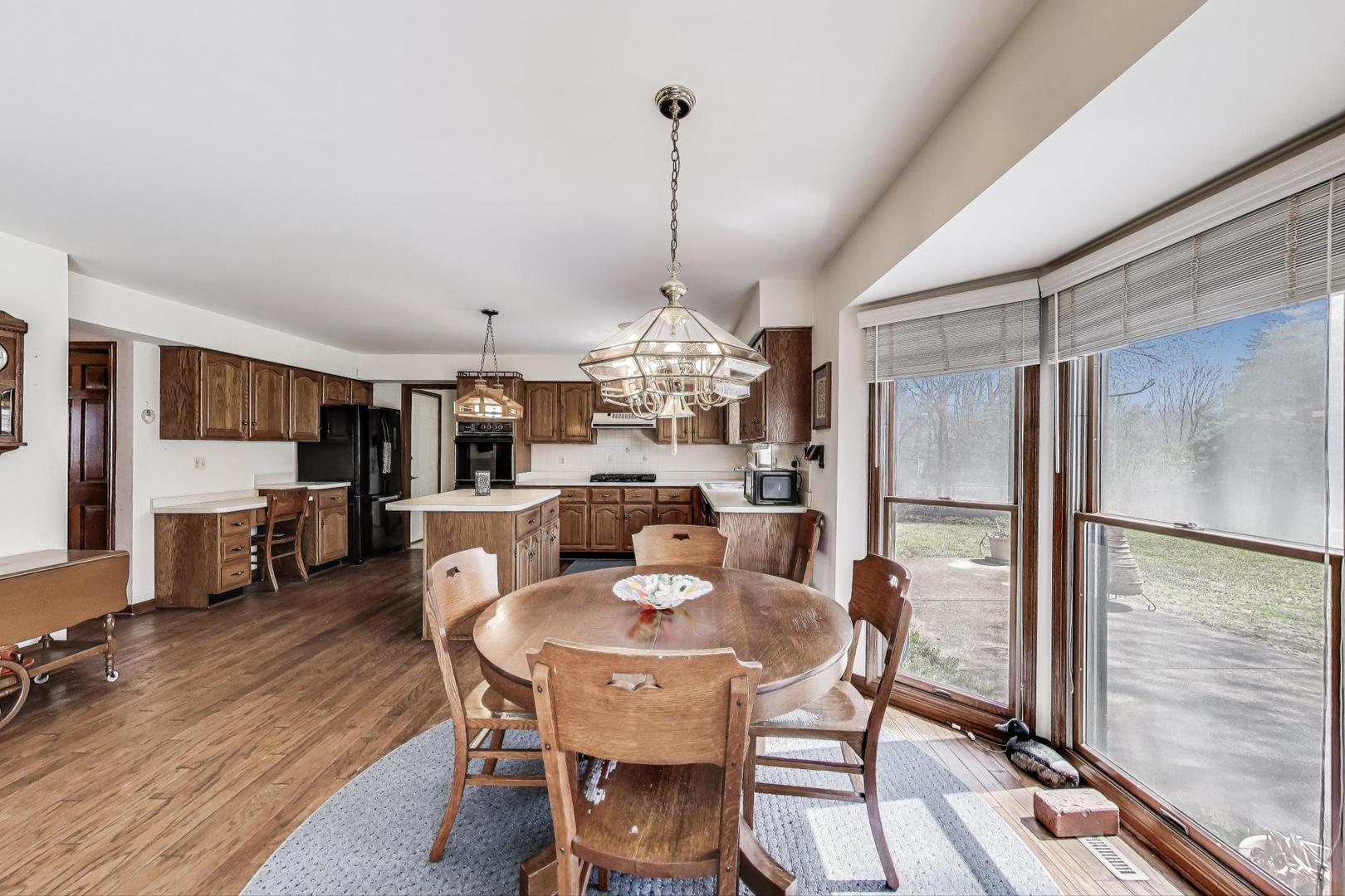 2080 Carolyn Road Aurora, IL 60506 - Photo 16 of 50 a dining room with furniture a chandelier and wooden floor