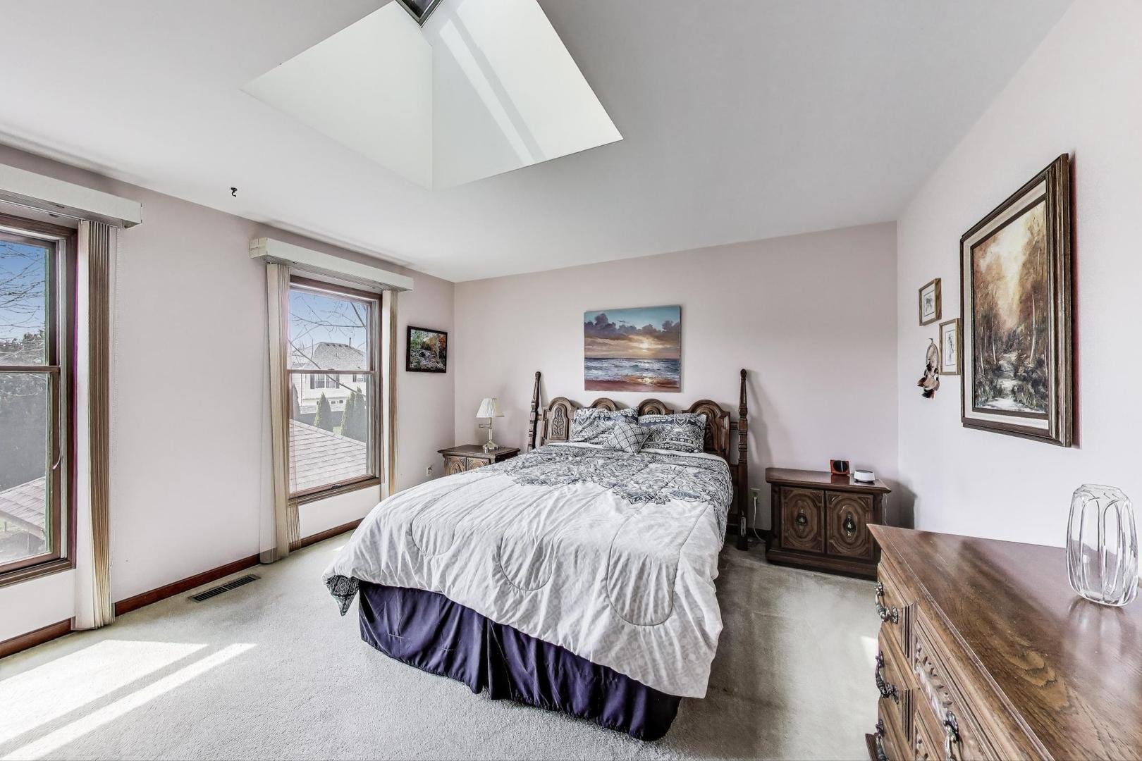 2080 Carolyn Road Aurora, IL 60506 - Photo 24 of 50 a bedroom with a bed and dresser with mirror