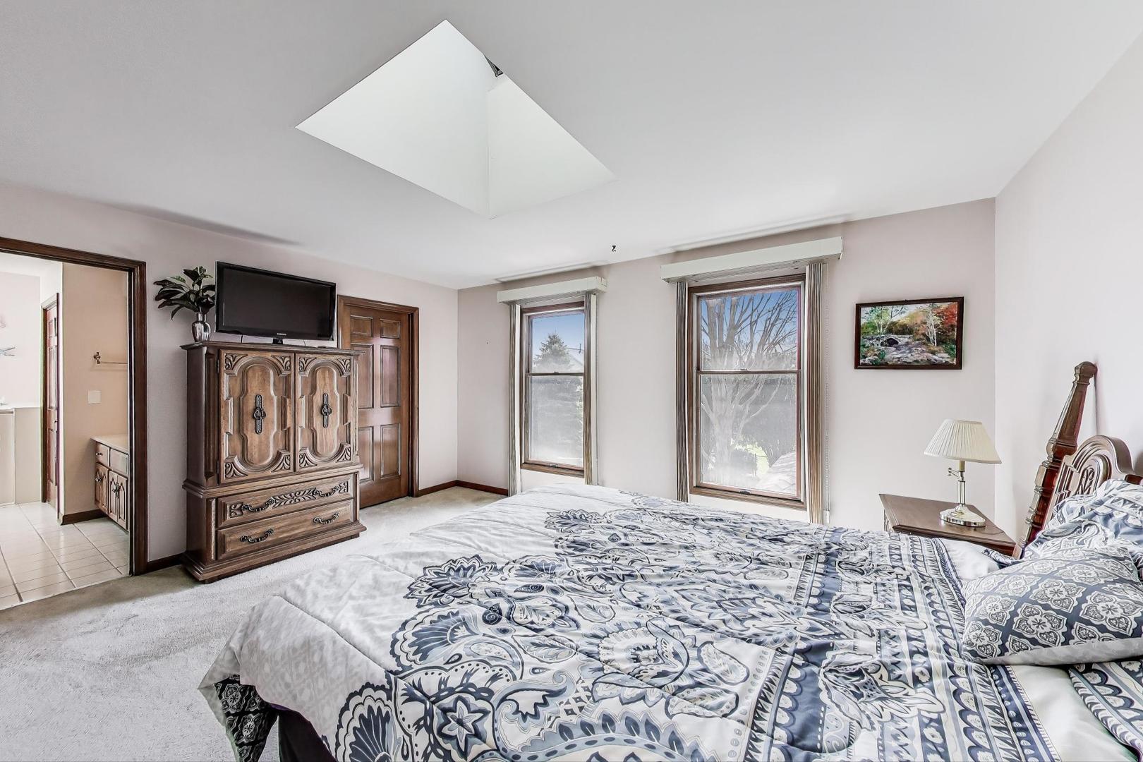 2080 Carolyn Road Aurora, IL 60506 - Photo 25 of 50 a spacious bedroom with a bed and cabinets