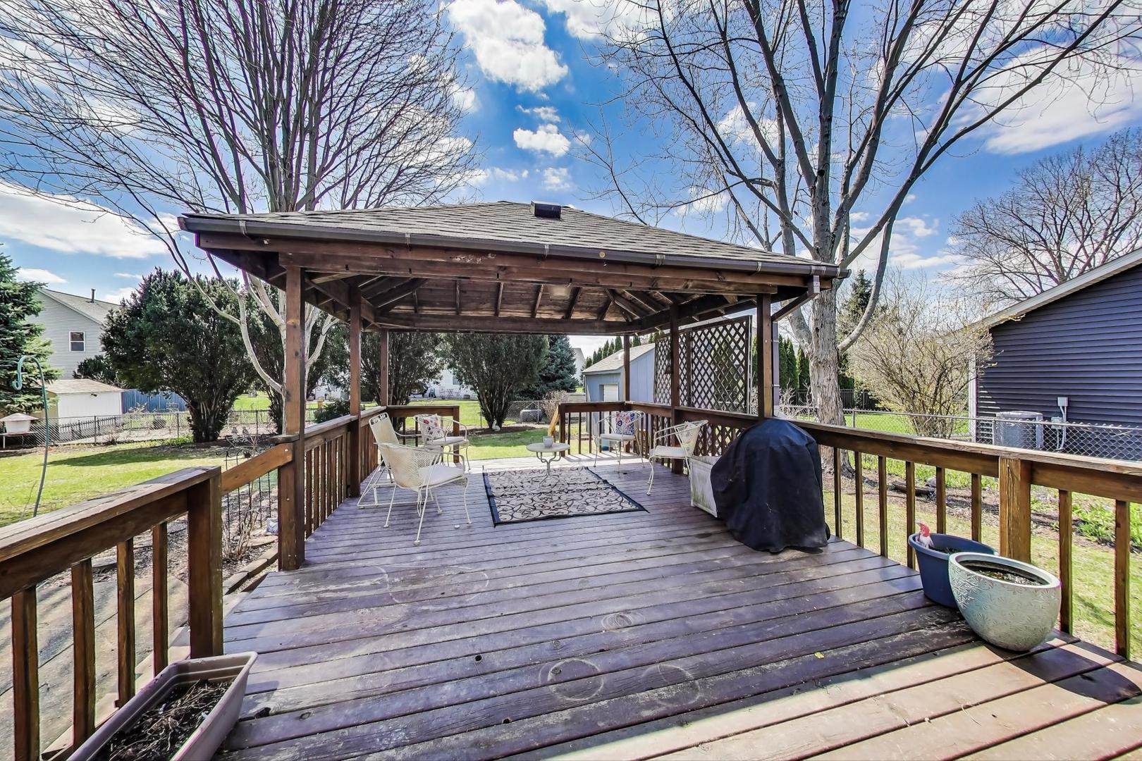 2080 Carolyn Road Aurora, IL 60506 - Photo 36 of 50 a view of a deck with chairs and wooden floor