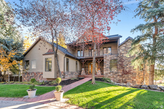 1146 Cottage Way Midway, UT 84049 - Photo 1 of 1 View of front of property featuring stone siding, a front yard, stucco siding, and a balcony