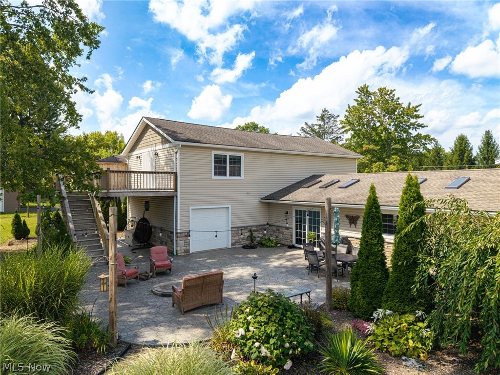 7996 Buffham Road Lodi, OH 44254 - Photo 4 of 40 Multi-level outdoor living spaces featuring a ground-level patio, an upper-level deck, and a lower-level garage