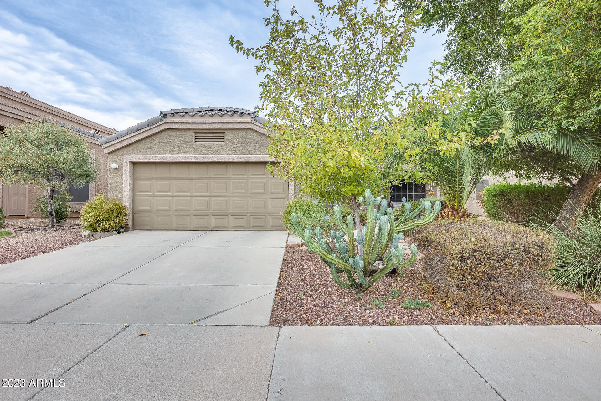 12722 West Boca Raton Road El Mirage, AZ 85335 - Photo 2 of 36 a front view of a house with garden