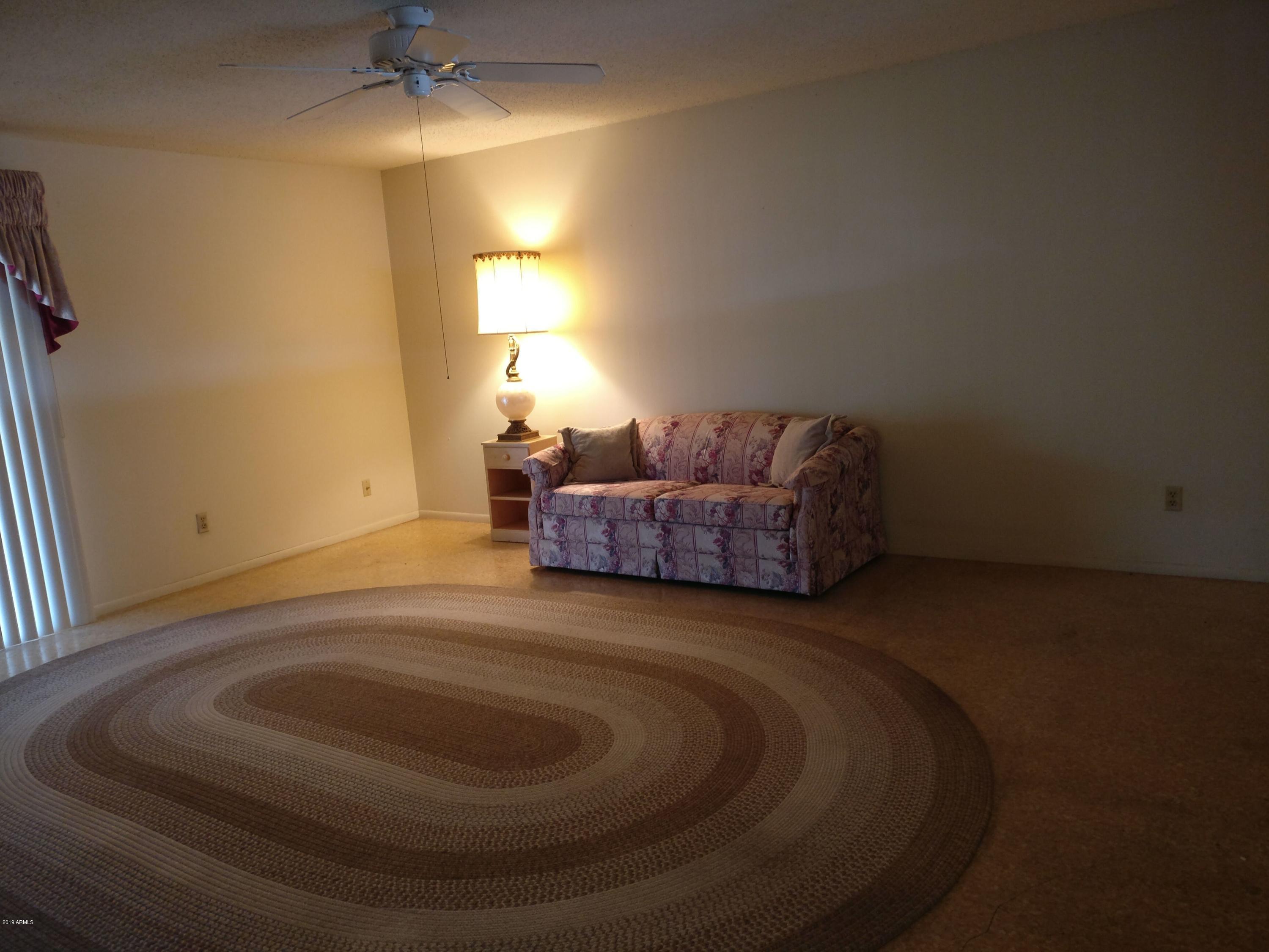 3733 West Ocotillo Road Phoenix, AZ 85019 - Photo 8 of 24 a living room with furniture and a fireplace
