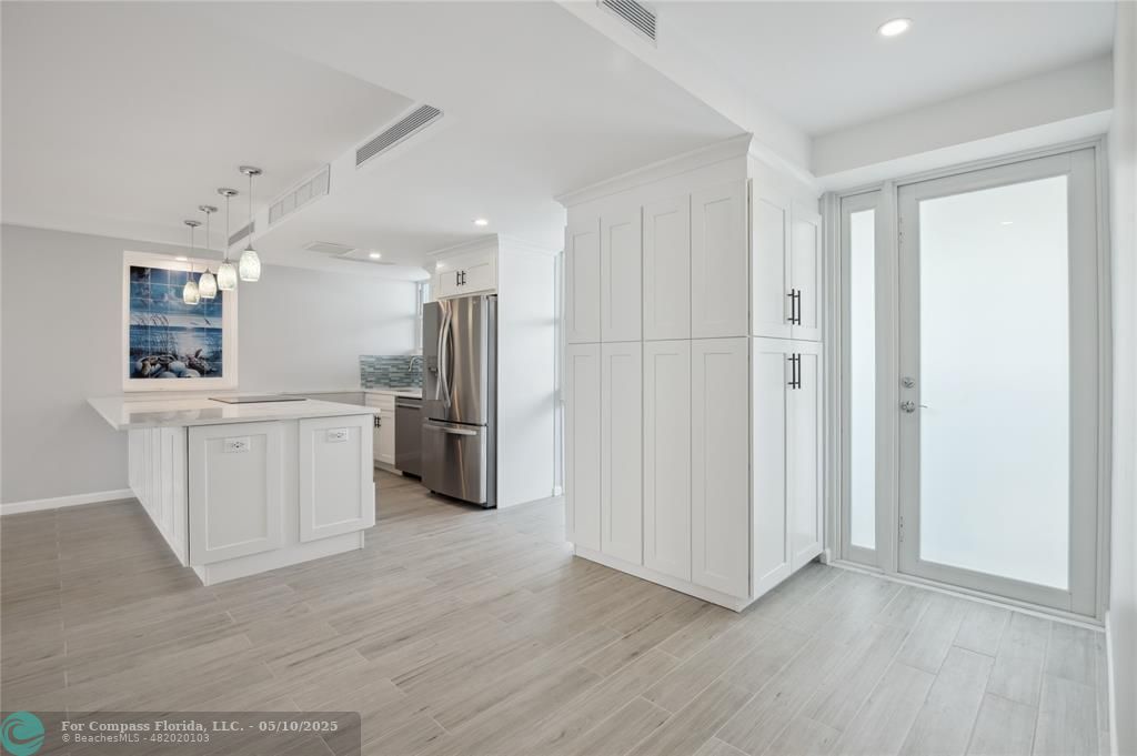Vast quartz kitchen island, complemented by all-new soft-close cabinets, drawers, top-quality appliances and gorgeous views of the ocean and Lake Mayan.