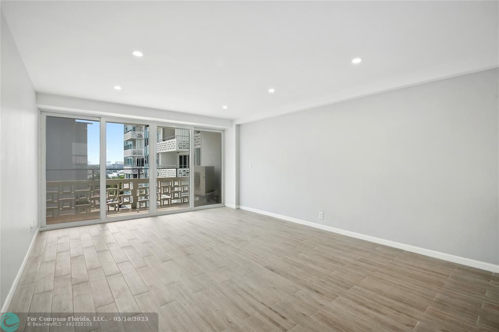 1900 South Ocean Drive, Unit 905 Fort Lauderdale, FL 33316 - Photo 13 of 41 Spacious living room with AC system fully concealed in the ceiling, enjoy Lake Mayan, Port Everglades and ocean views. All new wiring, dimmable light switches, 17 LED recessed lights throughout, a new balcony light, and USB charging ports integrated into the island outlets.