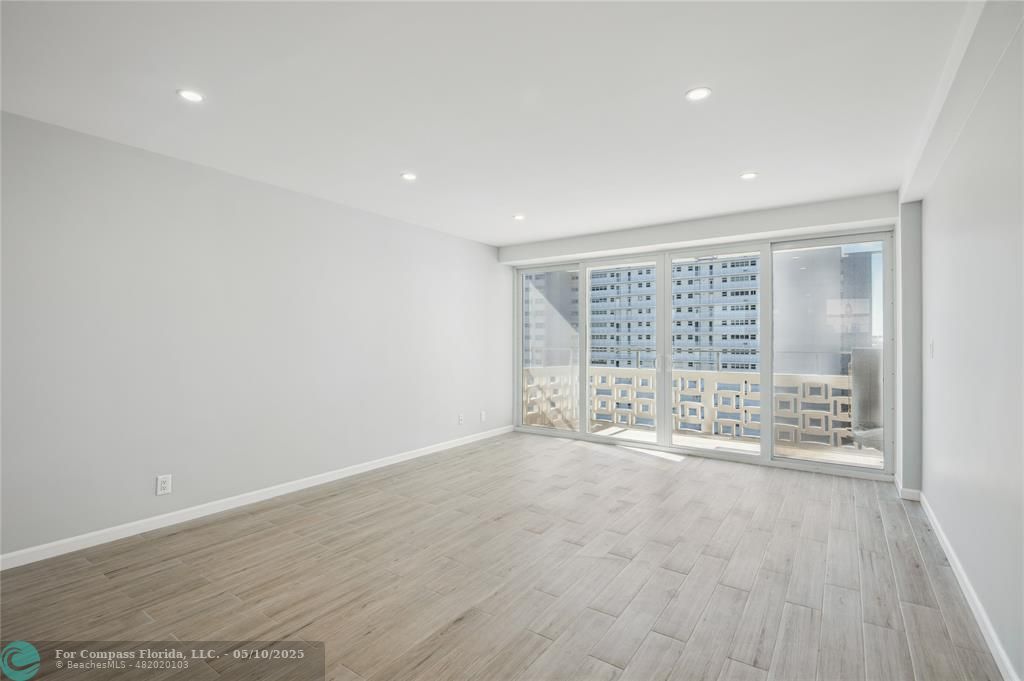 1900 South Ocean Drive, Unit 905 Fort Lauderdale, FL 33316 - Photo 14 of 41 Spacious living room with AC system fully concealed in the ceiling, enjoy Lake Mayan, Port Everglades and ocean views. All new wiring, dimmable light switches, 17 LED recessed lights throughout, a new balcony light, and USB charging ports integrated into the island outlets.