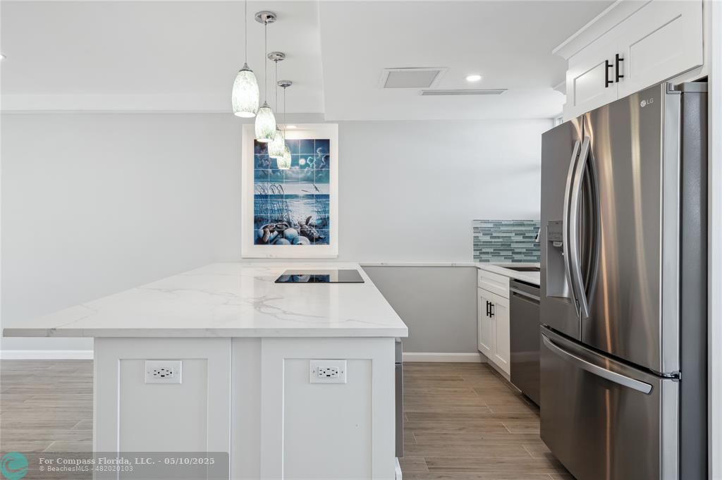 1900 South Ocean Drive, Unit 905 Fort Lauderdale, FL 33316 - Photo 19 of 41 Vast quartz kitchen island, complemented by all-new soft-close cabinets, drawers, top-quality appliances and gorgeous views of the ocean and Lake Mayan.