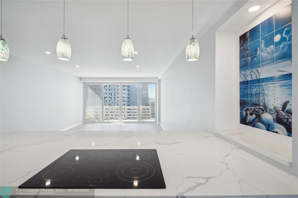 1900 South Ocean Drive, Unit 905 Fort Lauderdale, FL 33316 - Photo 20 of 41 Vast quartz kitchen island, complemented by all-new soft-close cabinets, drawers, top-quality appliances and gorgeous views of the ocean and Lake Mayan.