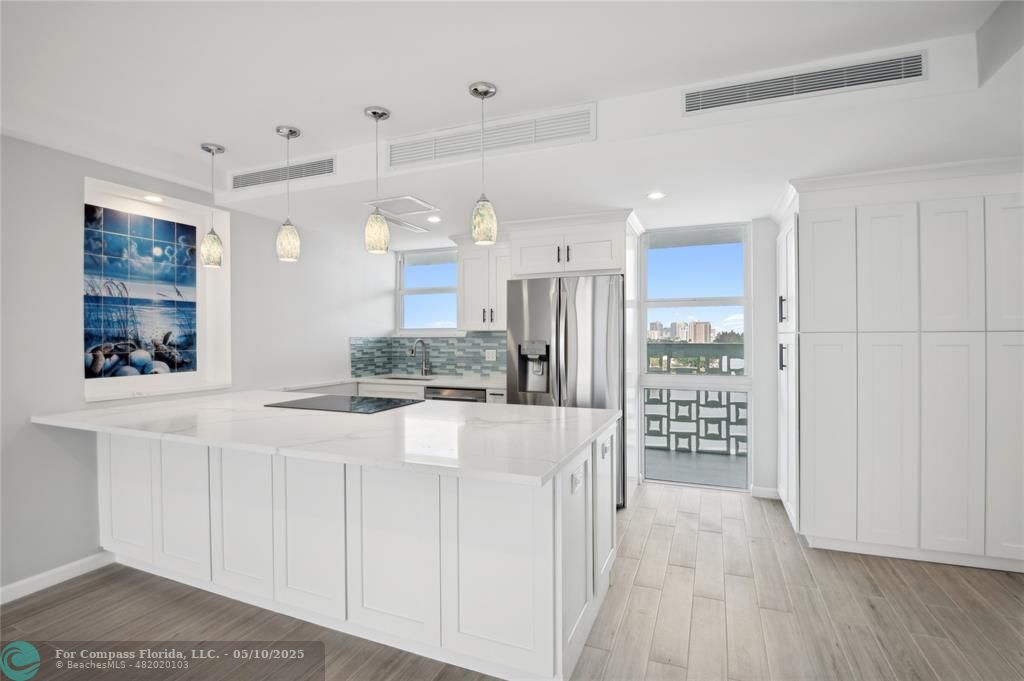 1900 South Ocean Drive, Unit 905 Fort Lauderdale, FL 33316 - Photo 2 of 41 Vast quartz kitchen island, complemented by all-new soft-close cabinets, drawers, top-quality appliances and gorgeous views of the ocean and Lake Mayan.