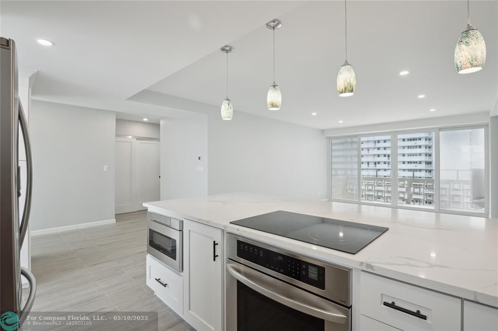 1900 South Ocean Drive, Unit 905 Fort Lauderdale, FL 33316 - Photo 6 of 41 Overlook your living room and balcony views while in your kitchen equipped with vast quartz island, complemented by all-new soft-close cabinets, drawers, top-quality appliances and gorgeous views of the ocean and Lake Mayan.