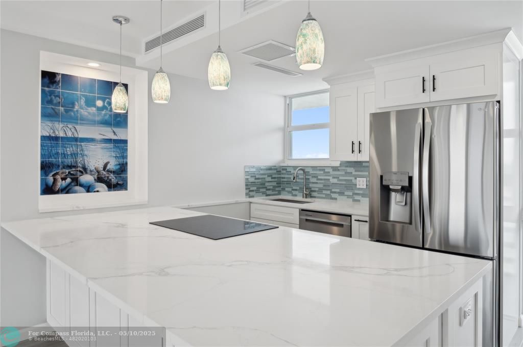 1900 South Ocean Drive, Unit 905 Fort Lauderdale, FL 33316 - Photo 7 of 41 Vast quartz kitchen island, complemented by all-new soft-close cabinets, drawers, top-quality appliances and gorgeous views of the ocean and Lake Mayan.