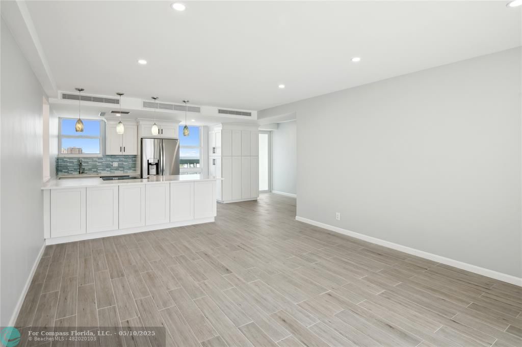 1900 South Ocean Drive, Unit 905 Fort Lauderdale, FL 33316 - Photo 9 of 41 Spacious living room with AC system fully concealed in the ceiling, enjoy Lake Mayan, Port Everglades and ocean views. All new wiring, dimmable light switches, 17 LED recessed lights throughout, a new balcony light, and USB charging ports integrated into the island outlets.