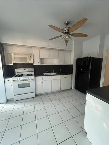 a kitchen with cabinets and appliances