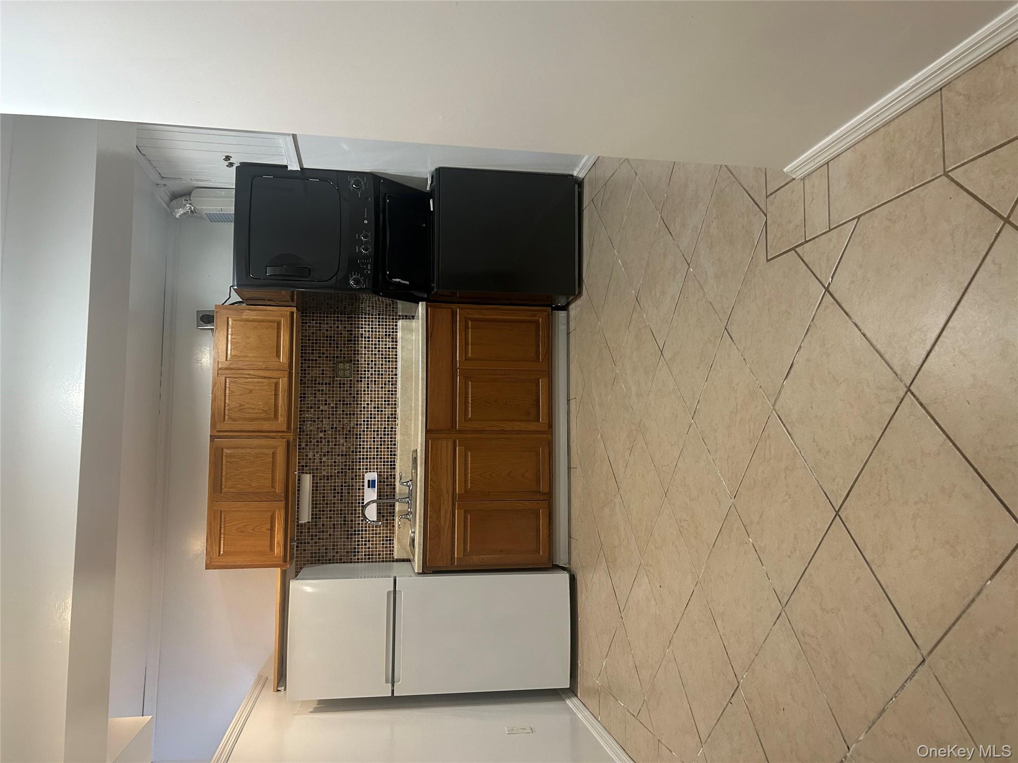 141 Sterling Avenue Yonkers, NY 10704 - Photo 12 of 23 a kitchen with cabinets and appliances