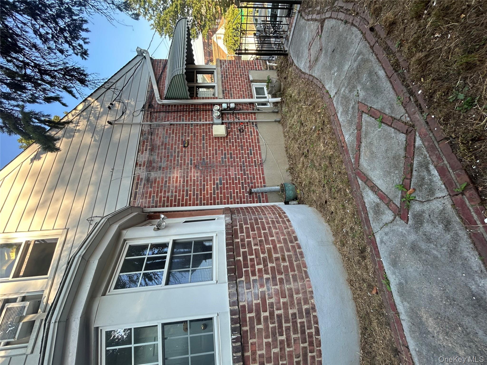 141 Sterling Avenue Yonkers, NY 10704 - Photo 4 of 23 a front view of a house with garden
