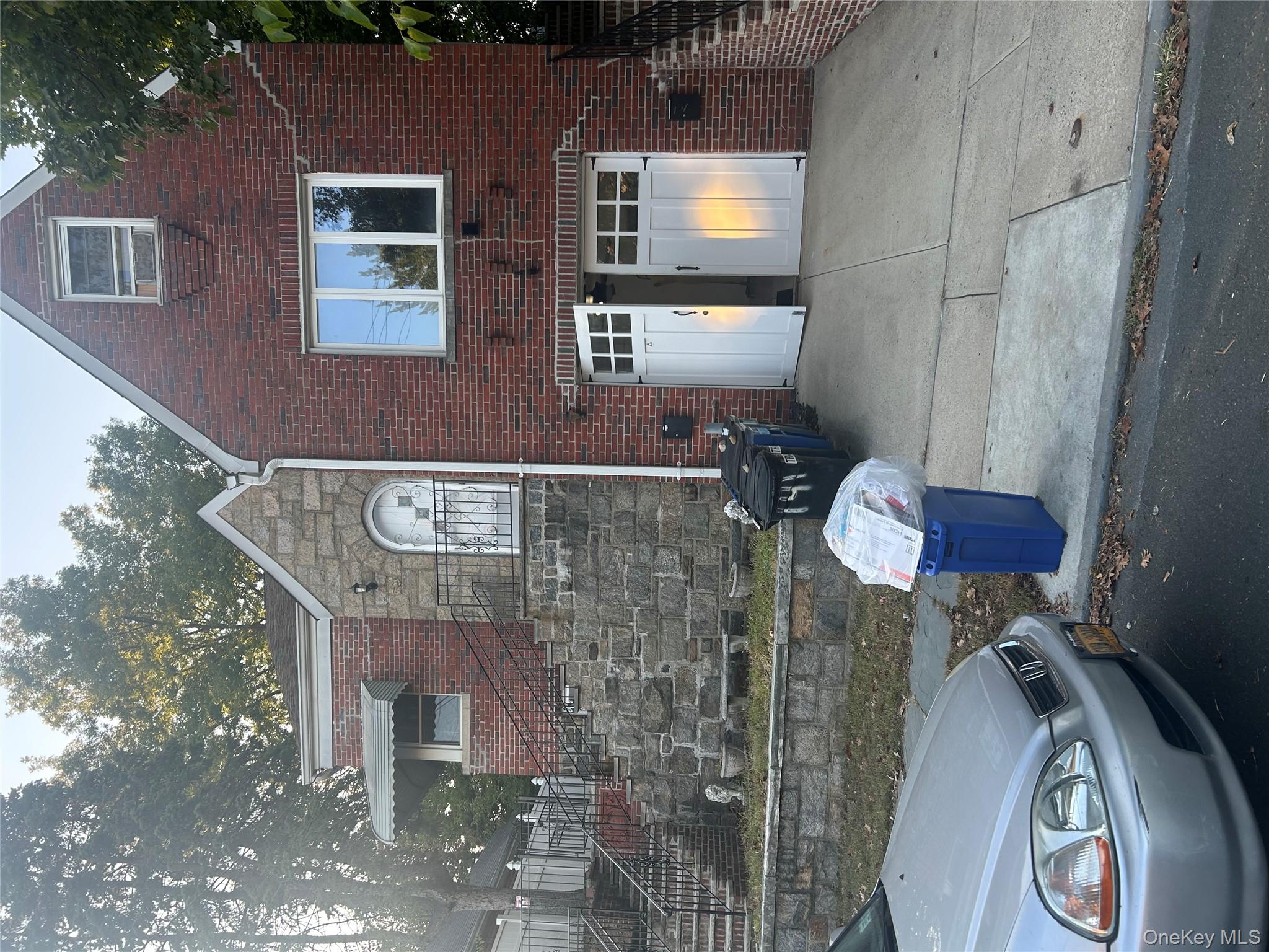 141 Sterling Avenue Yonkers, NY 10704 - Photo 5 of 23 a view of a house with back yard and a fire pit