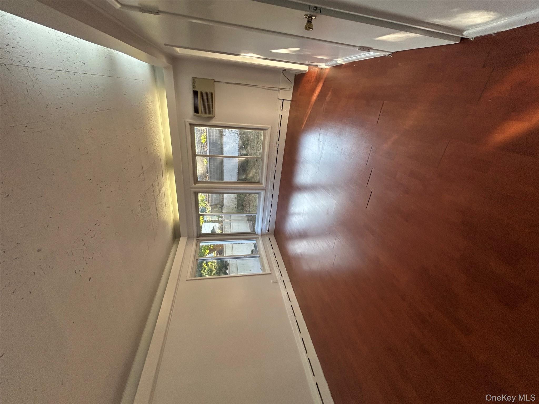 141 Sterling Avenue Yonkers, NY 10704 - Photo 9 of 23 a view of livingroom with hardwood floor and window