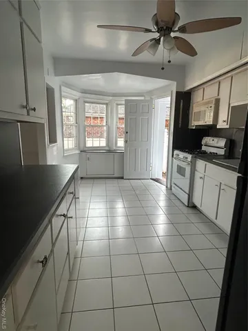 a view of a kitchen with a sink and a stove top oven