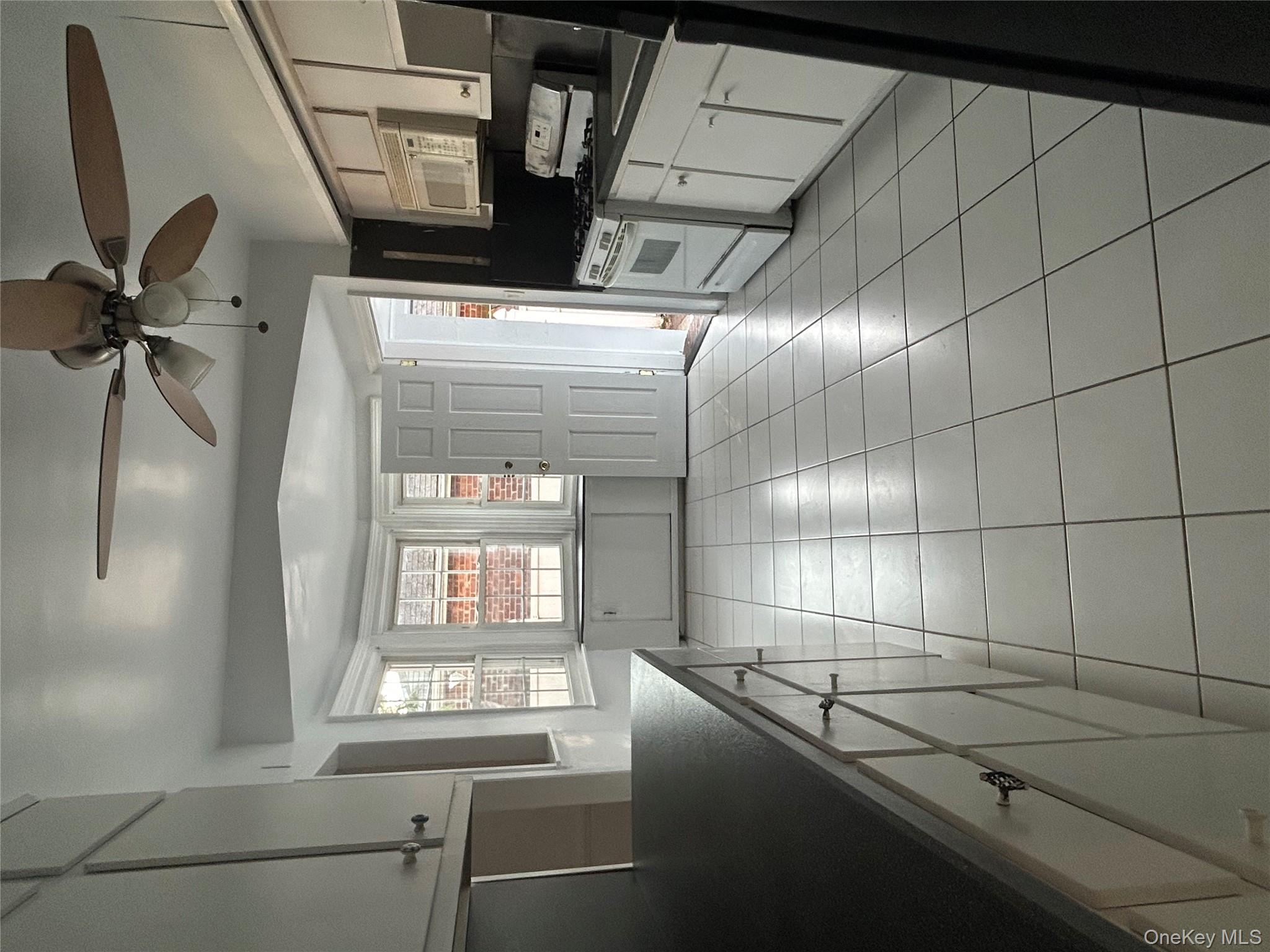 141 Sterling Avenue Yonkers, NY 10704 - Photo 10 of 23 a view of a kitchen with a sink and a stove top oven