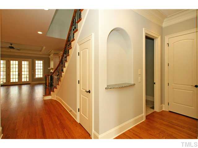 4188 English Garden Way Raleigh, NC 27612 - Photo 4 of 25 Luxury unfolds as you walk in to 10' ceilings w/ 4 piece crown moulding, hardwood floors, iron and custom detail.