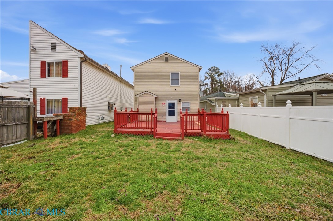 733 Spruce Street Hampton, VA 23661 - Photo 26 of 29 Back of property featuring a wooden deck and a fenced backyard