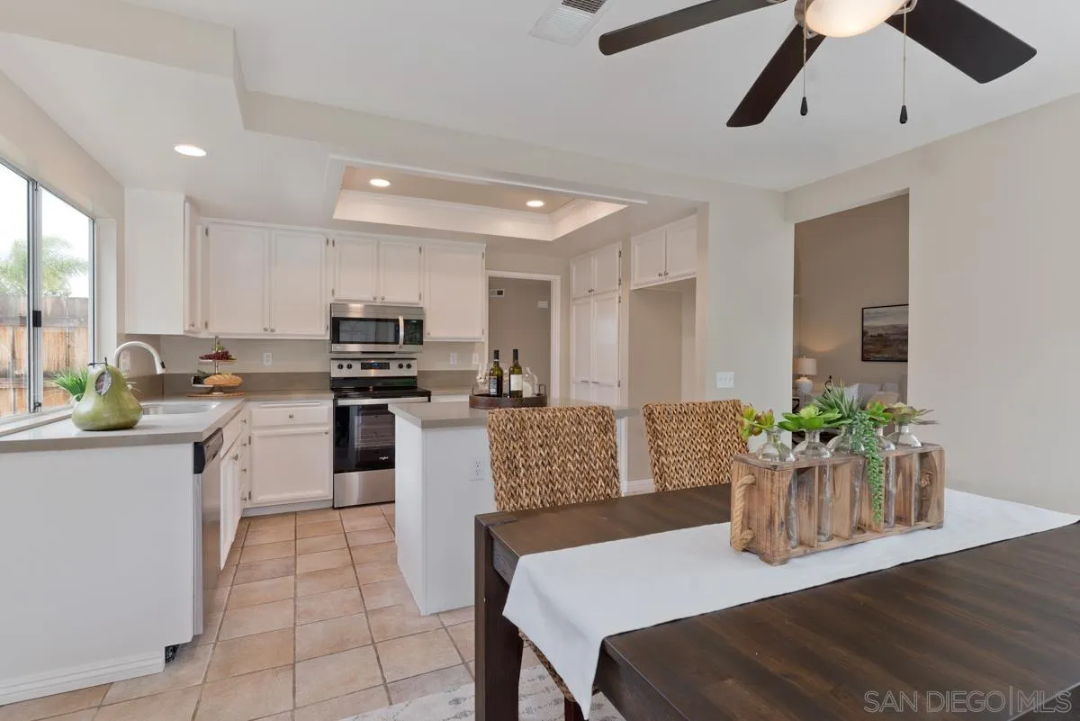 12515 Spindletop Road San Diego, CA 92129 - Photo 11 of 32 a kitchen with a table and chairs