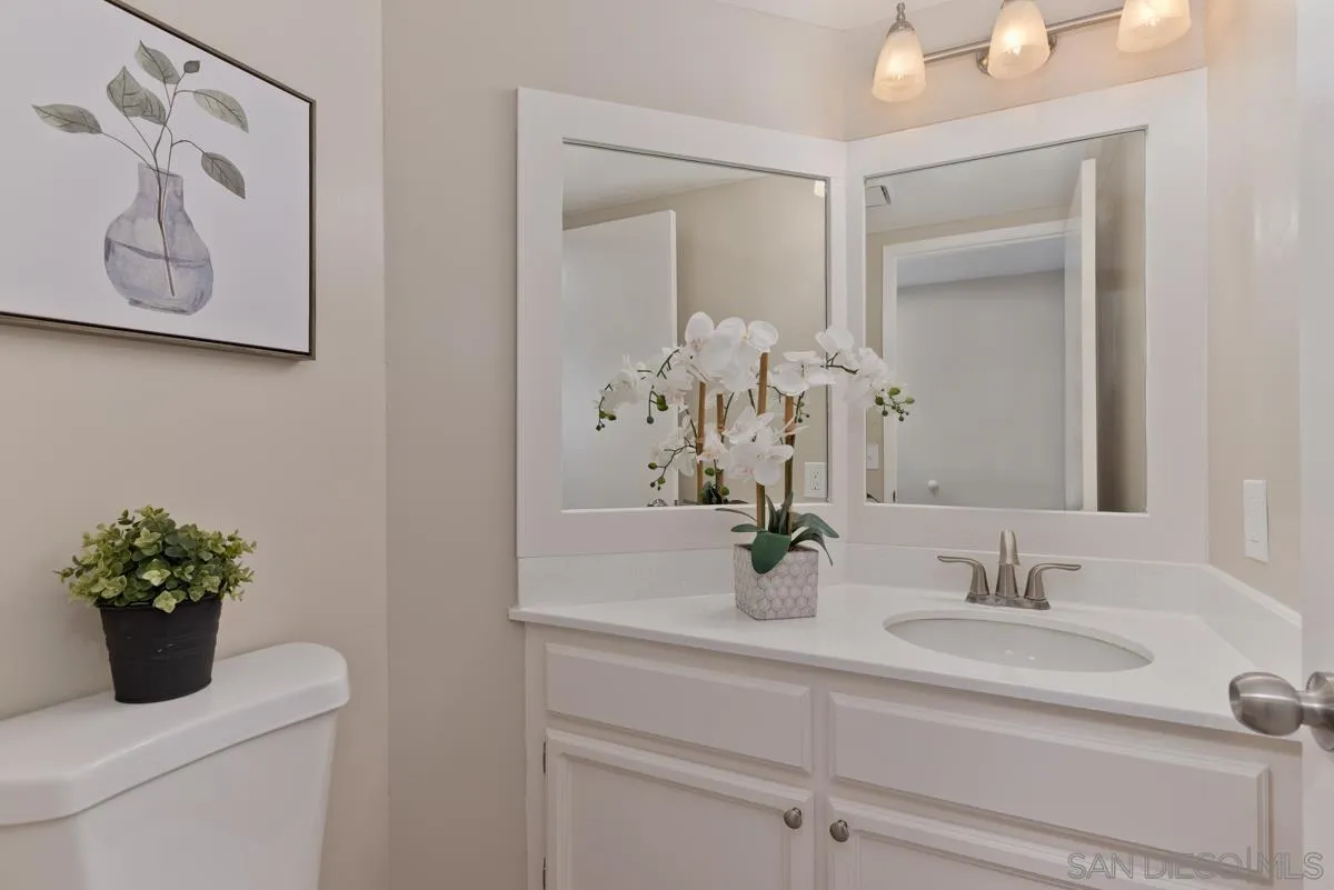 12515 Spindletop Road San Diego, CA 92129 - Photo 19 of 32 a bathroom with a sink a toilet and mirror