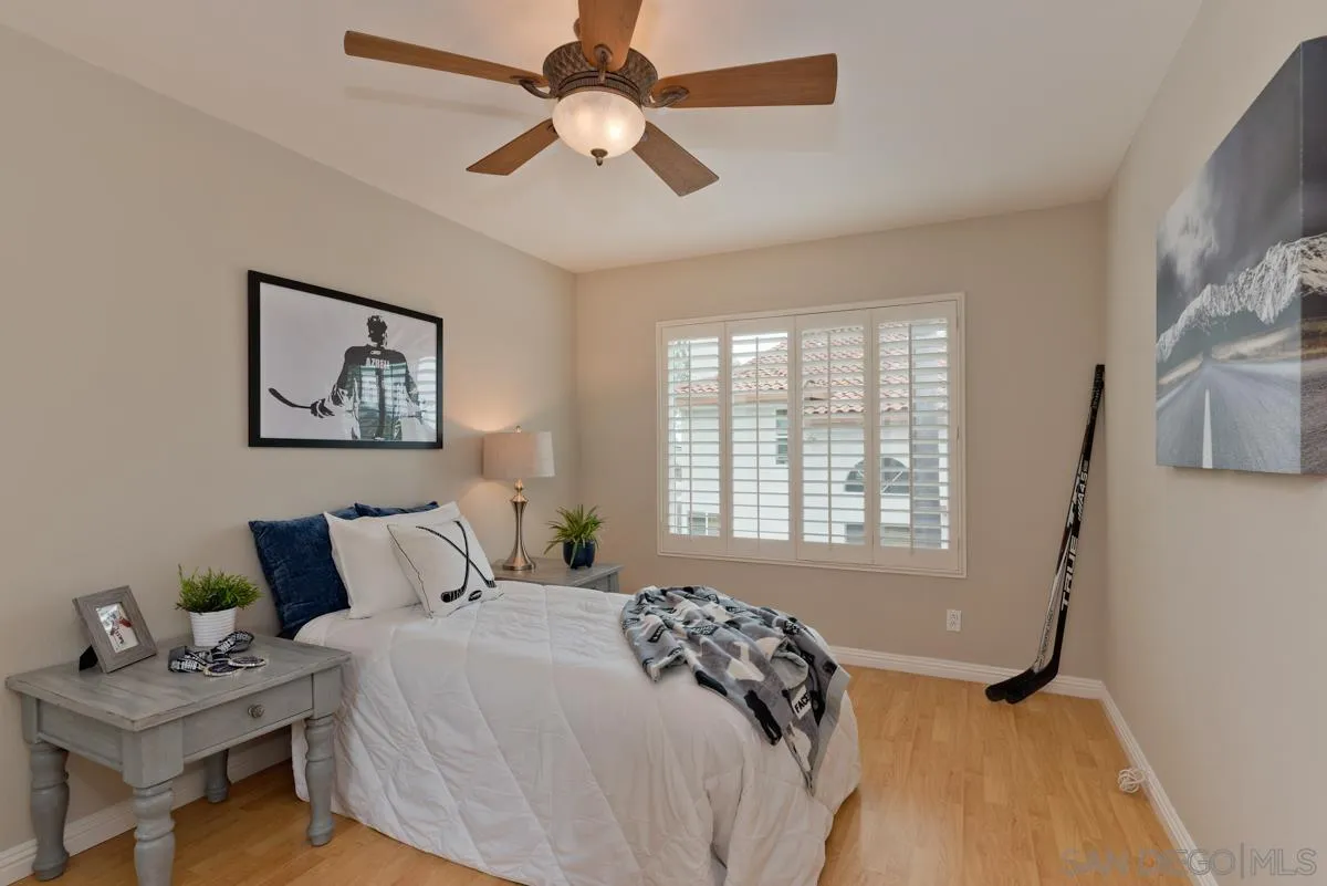 12515 Spindletop Road San Diego, CA 92129 - Photo 21 of 32 a bedroom with a bed and a window