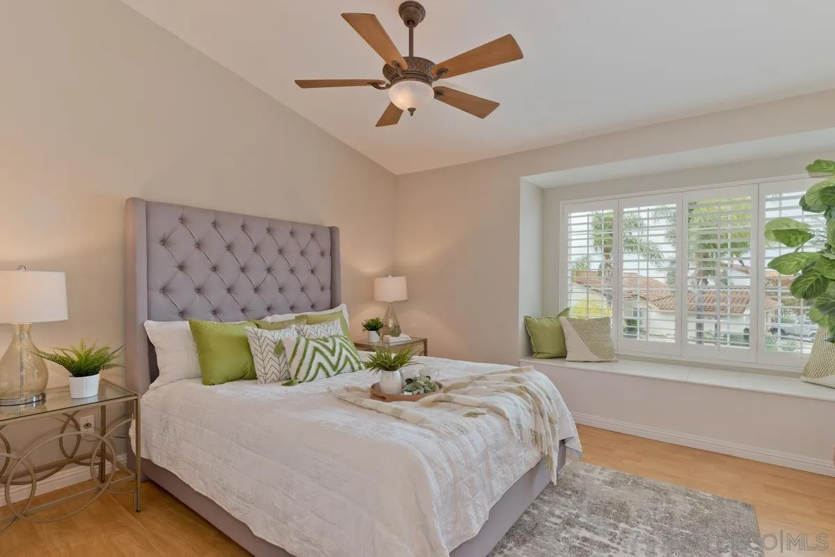 12515 Spindletop Road San Diego, CA 92129 - Photo 24 of 32 a bedroom with a large bed and a large window