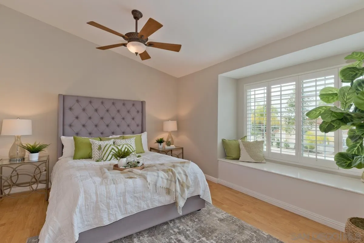 12515 Spindletop Road San Diego, CA 92129 - Photo 25 of 32 a bedroom with a bed and a large window