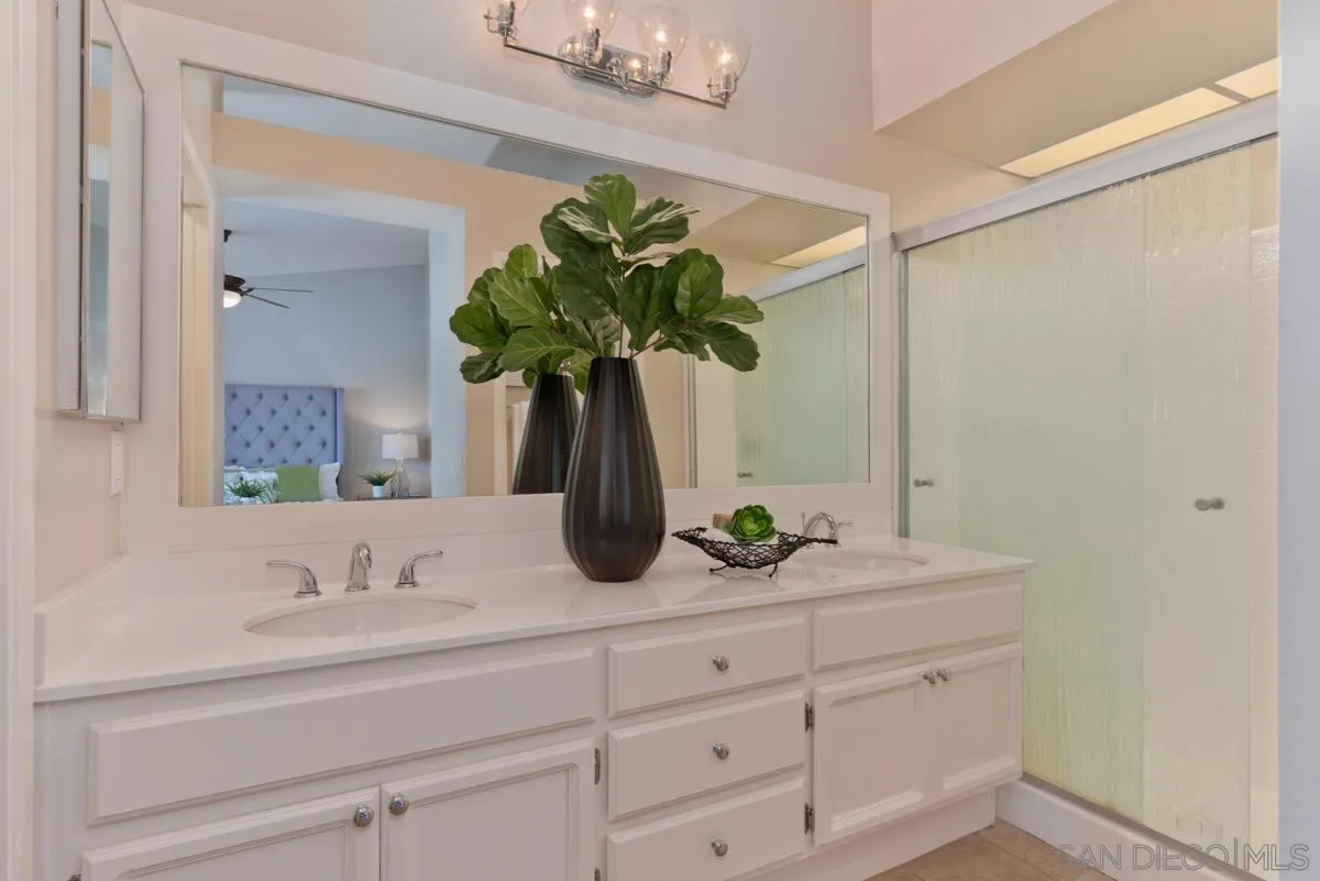 12515 Spindletop Road San Diego, CA 92129 - Photo 26 of 32 a bathroom with a sink a vanity and a mirror