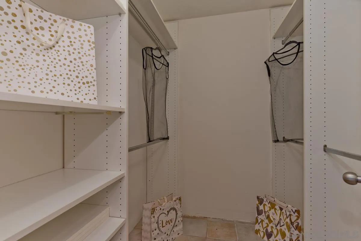 12515 Spindletop Road San Diego, CA 92129 - Photo 27 of 32 a bathroom with a bathtub and shower