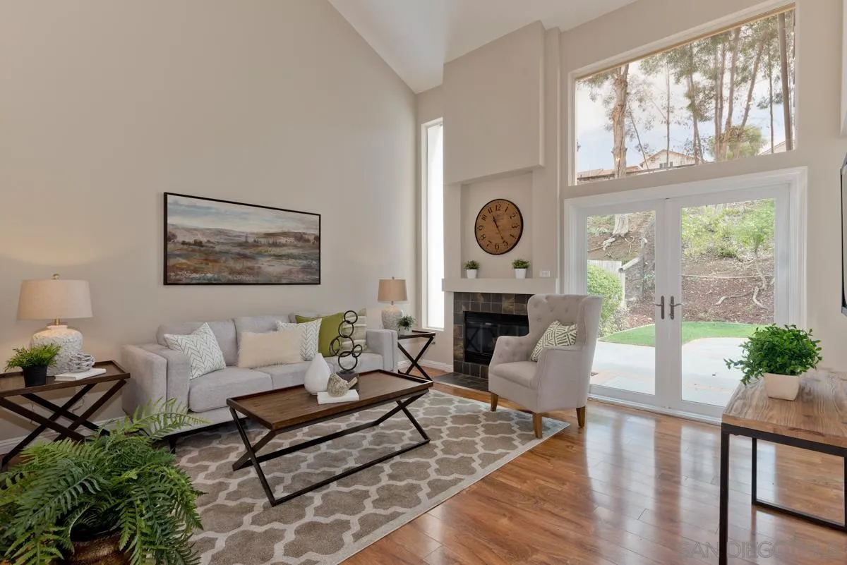 12515 Spindletop Road San Diego, CA 92129 - Photo 5 of 32 a living room with furniture a fireplace and a large window