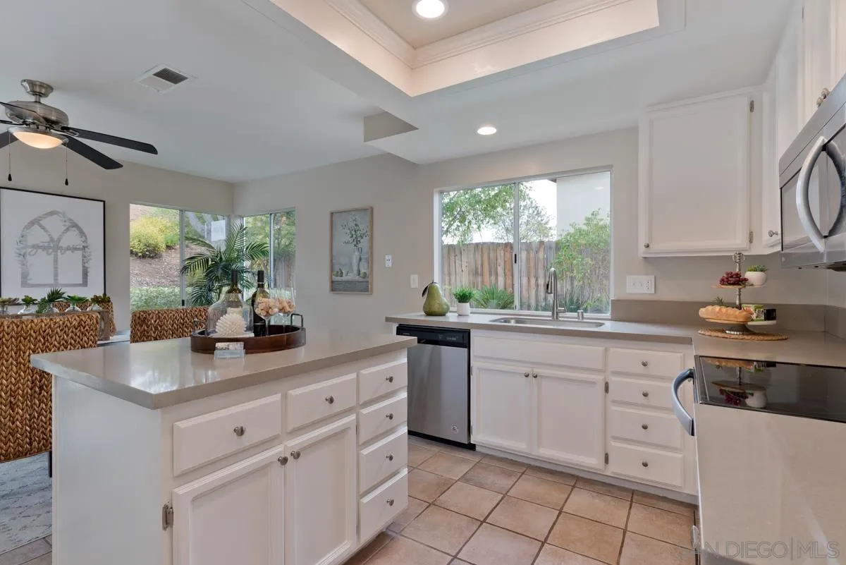 12515 Spindletop Road San Diego, CA 92129 - Photo 6 of 32 a kitchen with white cabinets and a stove