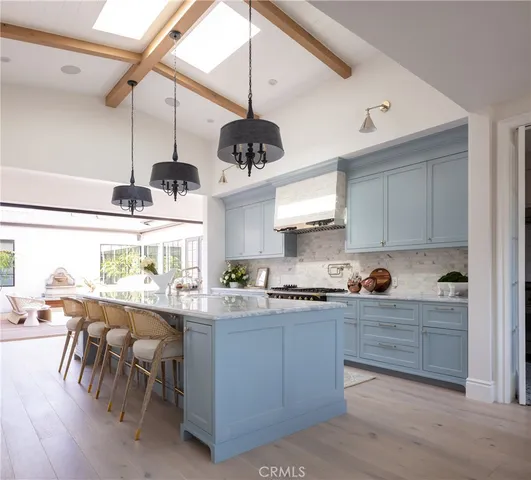 a kitchen with stainless steel appliances granite countertop a sink a stove and a refrigerator