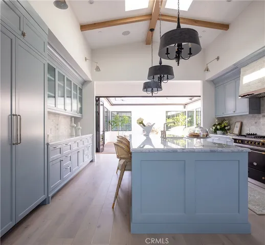 a kitchen with stainless steel appliances granite countertop a stove and a refrigerator