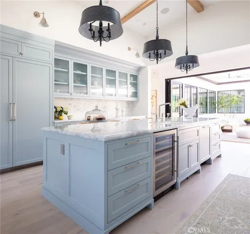 a kitchen with a sink and chandelier