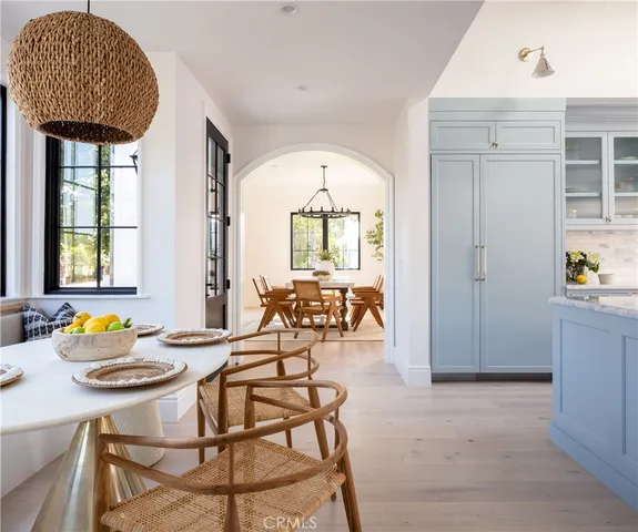 a kitchen with white cabinets and appliances